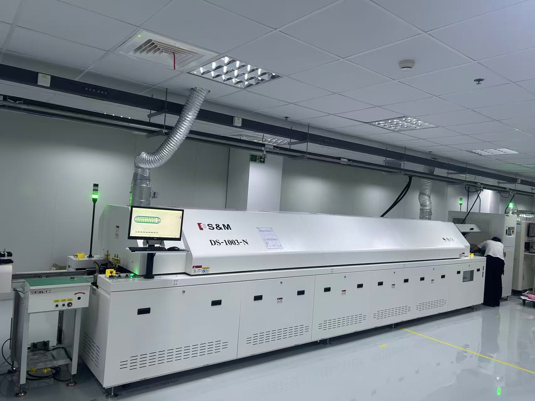 S&M reflow oven installed in an electronics production line